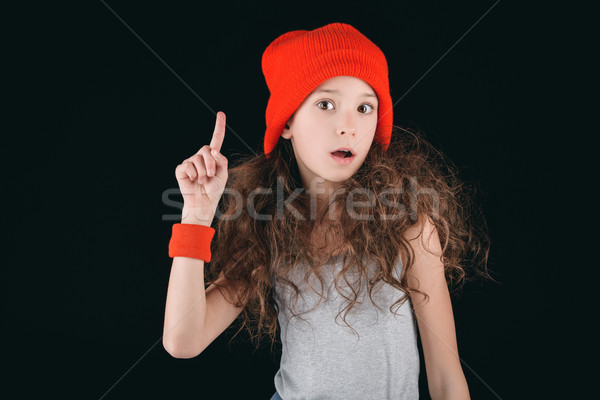 shocked girl in sportive clothing with finger up isolated on black Stock photo © LightFieldStudios