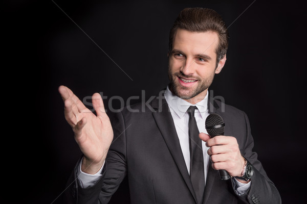 Young man with microphone Stock photo © LightFieldStudios