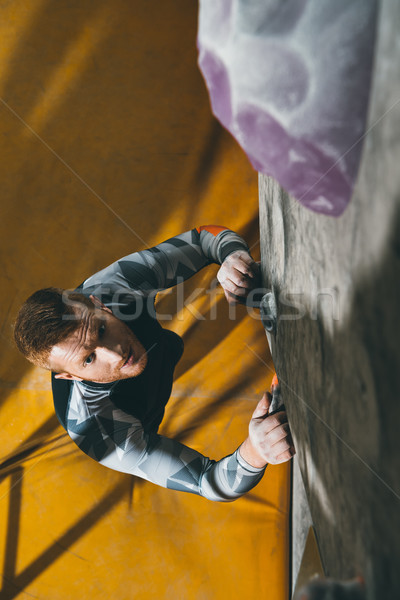 Man climbing wall with grips Stock photo © LightFieldStudios