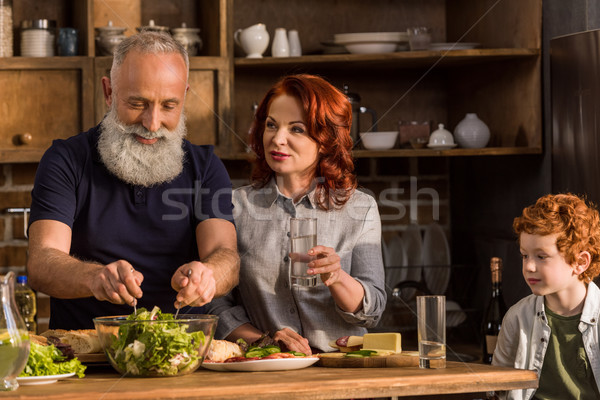 Grands-parents peu garçon portrait cuisson salade Photo stock © LightFieldStudios