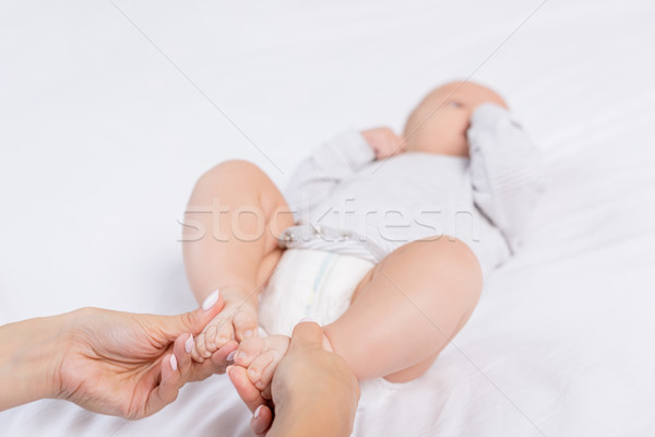 mother holding babys feet Stock photo © LightFieldStudios