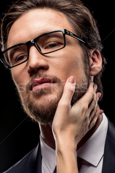 Businessman with female hand on face Stock photo © LightFieldStudios