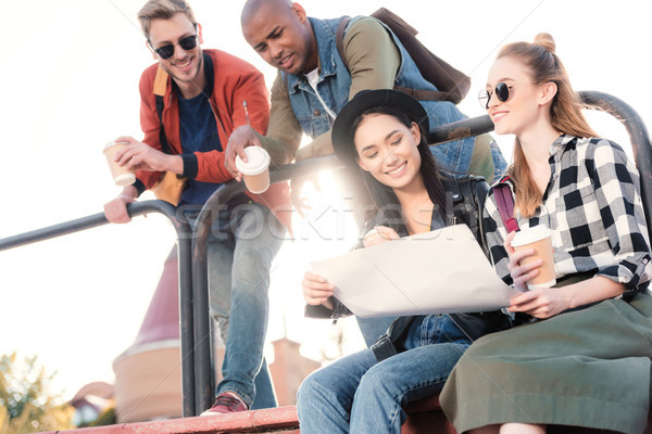 multicultural friends looking at map Stock photo © LightFieldStudios