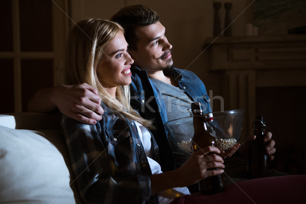side view of smiling couple watching movie with popcorn and beer Stock photo © LightFieldStudios