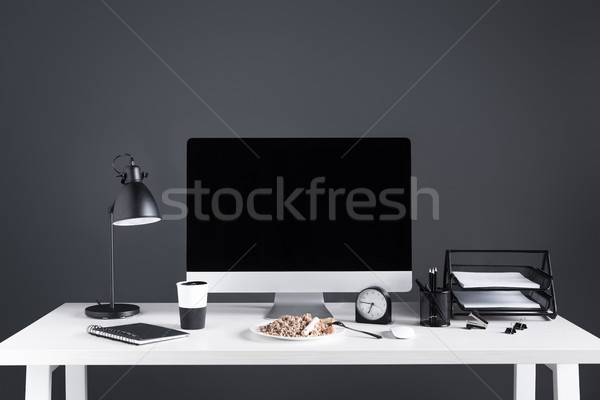 desktop computer with blank screen, food on plate and office supplies at workplace Stock photo © LightFieldStudios