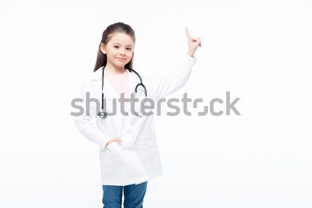 Menina médico traje sorridente little girl indicação Foto stock © LightFieldStudios