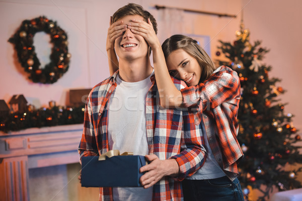 Fille surprenant copain Noël souriant yeux [[stock_photo]] © LightFieldStudios