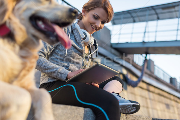 sportswoman using digital tablet Stock photo © LightFieldStudios