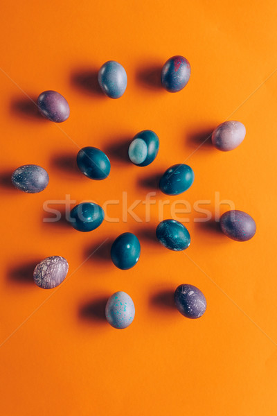 flat lay of colored painted easter eggs on orange Stock photo © LightFieldStudios