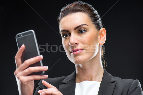 Businesswoman using smartphone Stock photo © LightFieldStudios