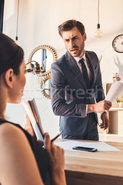 Businessman reprehending secretery Stock photo © LightFieldStudios