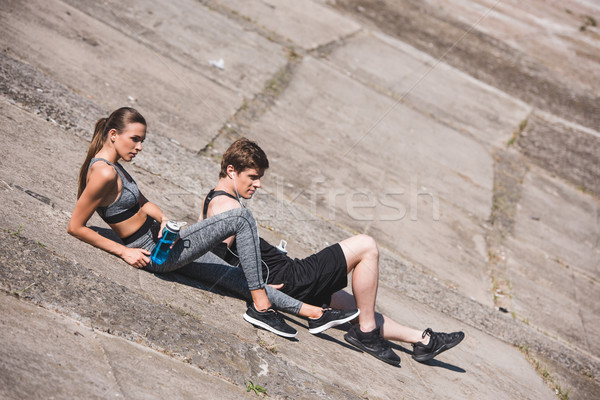 sportive couple resting on slabs Stock photo © LightFieldStudios