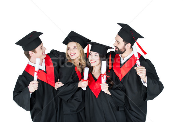 Happy students in academic caps standing embracing with diplomas   Stock photo © LightFieldStudios
