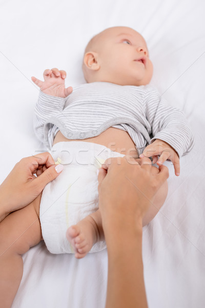 mother changing babys diaper Stock photo © LightFieldStudios