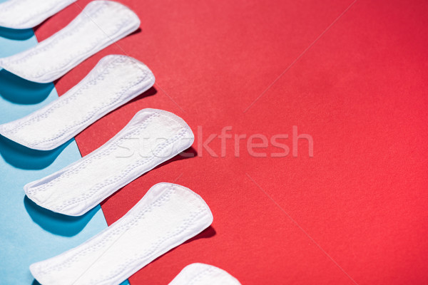 high angle view of row of daily pads on blue and red Stock photo © LightFieldStudios