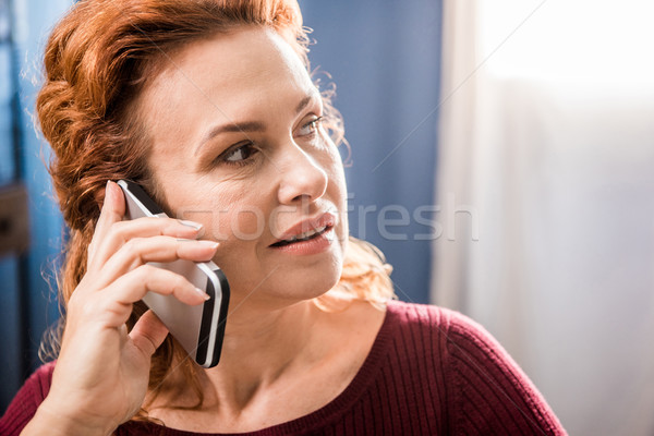 Woman talking on smartphone Stock photo © LightFieldStudios