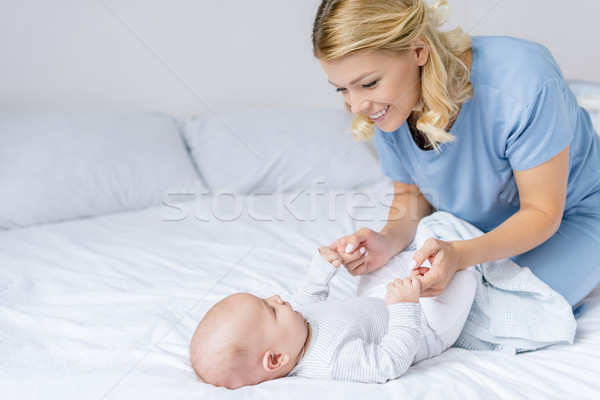 mother holding babys hands Stock photo © LightFieldStudios