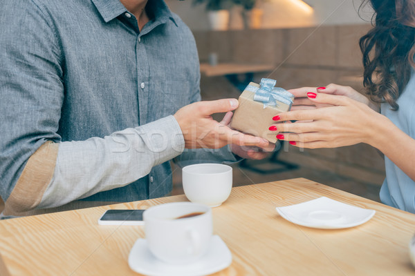 man giving present to woman Stock photo © LightFieldStudios