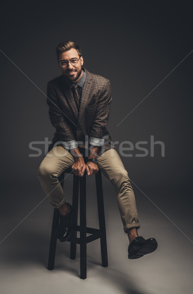 man in suit sitting on bar stool Stock photo © LightFieldStudios