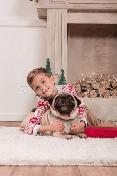 boy with christmas gift and pug Stock photo © LightFieldStudios