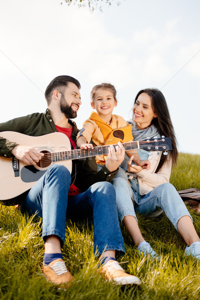 man playing guitar with family Stock photo © LightFieldStudios