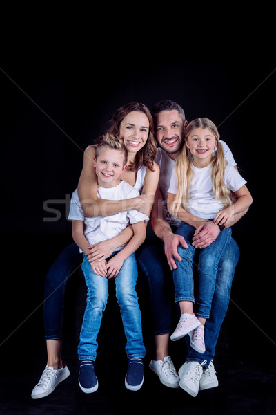family sitting together and looking at camera Stock photo © LightFieldStudios