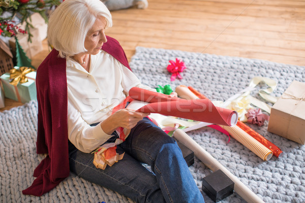 Stock photo: Woman wrapping christmas presents