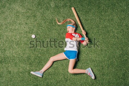 Stock photo: top view of little sportive girl catching rugby ball on grass, athletics children concept