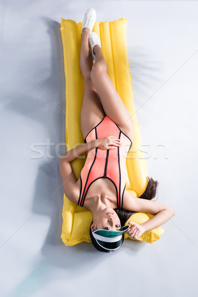 Vrouw zwempak zwembad matras shot mooie Stockfoto © LightFieldStudios