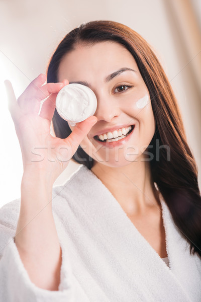 woman showing open jar of cream Stock photo © LightFieldStudios