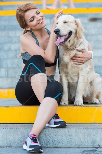 sportswoman sitting with dog Stock photo © LightFieldStudios