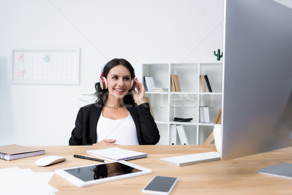 pregnant businesswoman relaxing and listening music Stock photo © LightFieldStudios