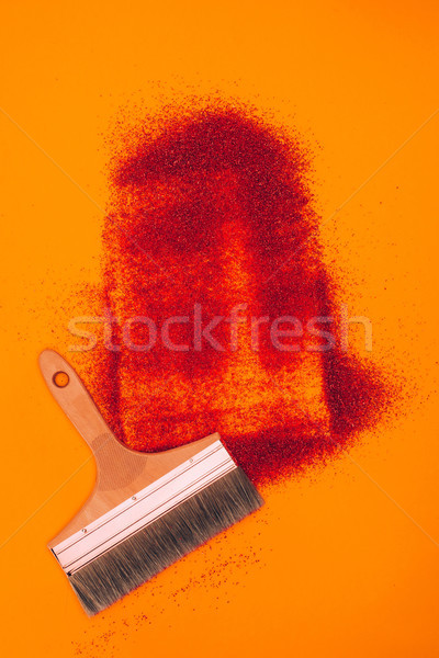 top view of red sand for decoration and brush isolated on orange Stock photo © LightFieldStudios