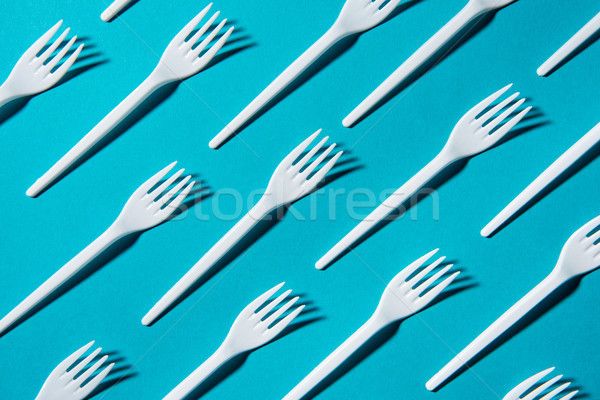 top view of set of plastic forks isolated on blue Stock photo © LightFieldStudios