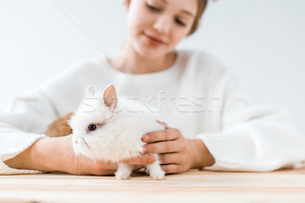 selective focus of smiling girl holding cute furry rabbit on white  Stock photo © LightFieldStudios