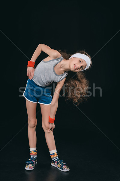 girl in sportswear exercising isolated on black. acting kids, 11 year old kids concept  Stock photo © LightFieldStudios