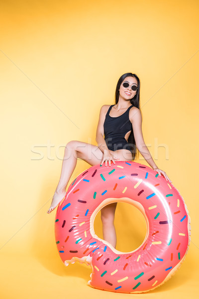 woman in swimsuit with doughnut pool float Stock photo © LightFieldStudios