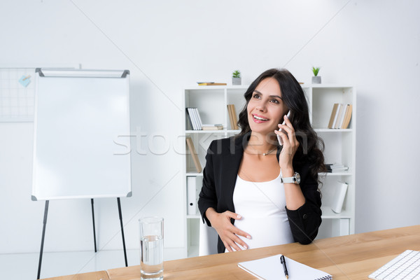 pregnant businesswoman talking by phone Stock photo © LightFieldStudios