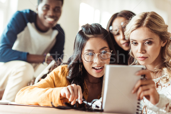 excited students looking at notebook Stock photo © LightFieldStudios
