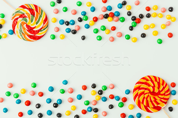 top view of arranged lollipops and candies isolated on white Stock photo © LightFieldStudios
