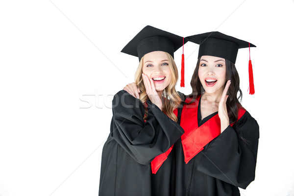 attractive excited students in graduation caps hugging isolated on white  Stock photo © LightFieldStudios