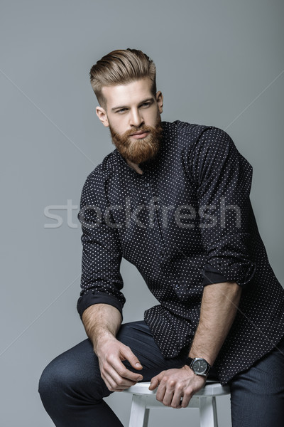 portrait of stylish bearded man on chair on grey Stock photo © LightFieldStudios