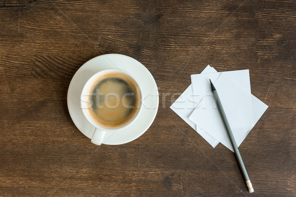 Top view of blank papers with pencil and cup of coffee on wooden table top Stock photo © LightFieldStudios