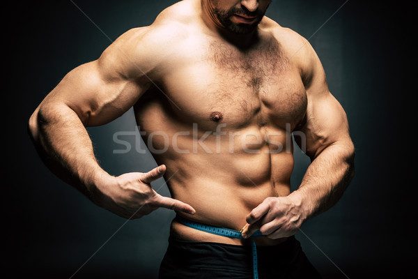 Stock photo: sportive man with measuring tape