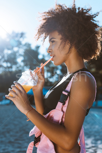 african-american woman drinking juice Stock photo © LightFieldStudios