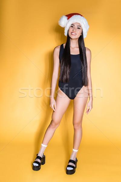 Asian woman in santa hat and swimsuit Stock photo © LightFieldStudios