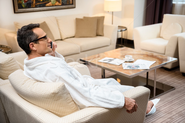 Businessman in hotel talking on phone Stock photo © LightFieldStudios