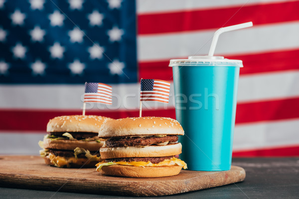 close up view of burgers with american flags and soda drink, presidents day celebration concept Stock photo © LightFieldStudios