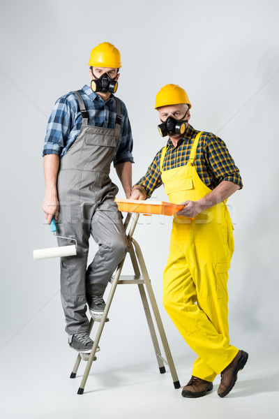 Workmen with paint roller Stock photo © LightFieldStudios