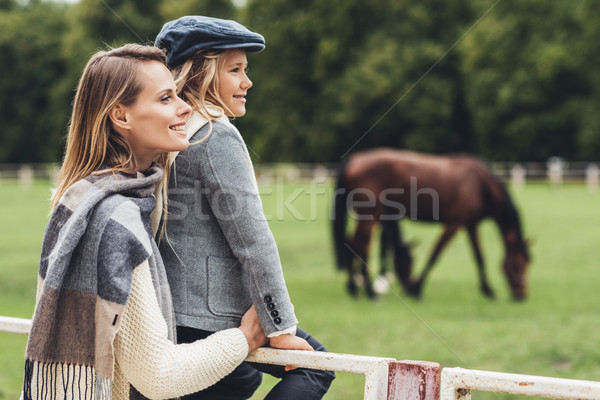 mother and daughter at paddock with horse Stock photo © LightFieldStudios